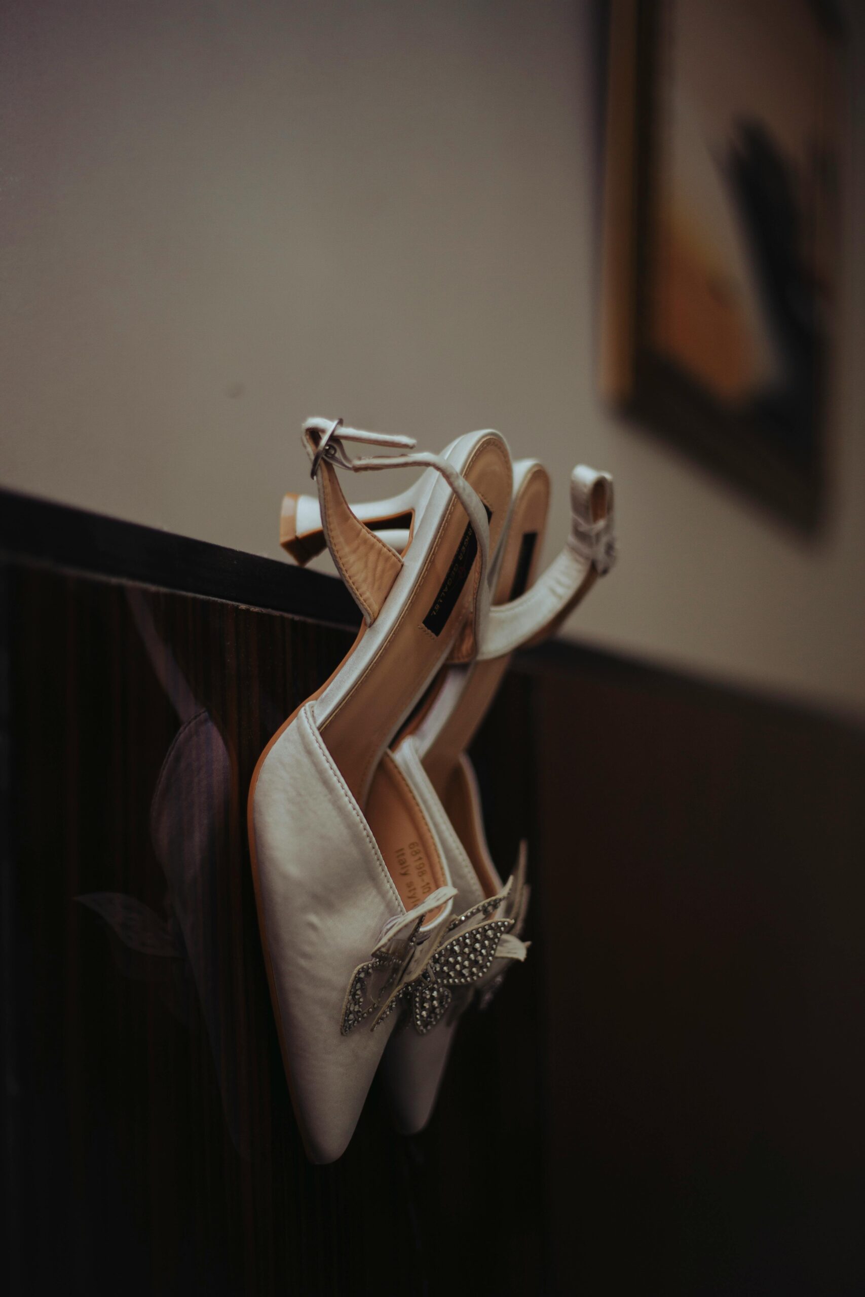 pexels-photo-29536888-29536888 Stylish white bridal shoes with rhinestone accents, perfect for a wedding day.