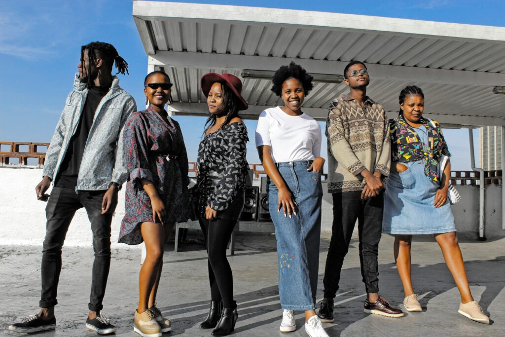 pexels-photo-7311070-7311070 Stylish young adults in diverse fashion posing together on a rooftop under a sunny sky.